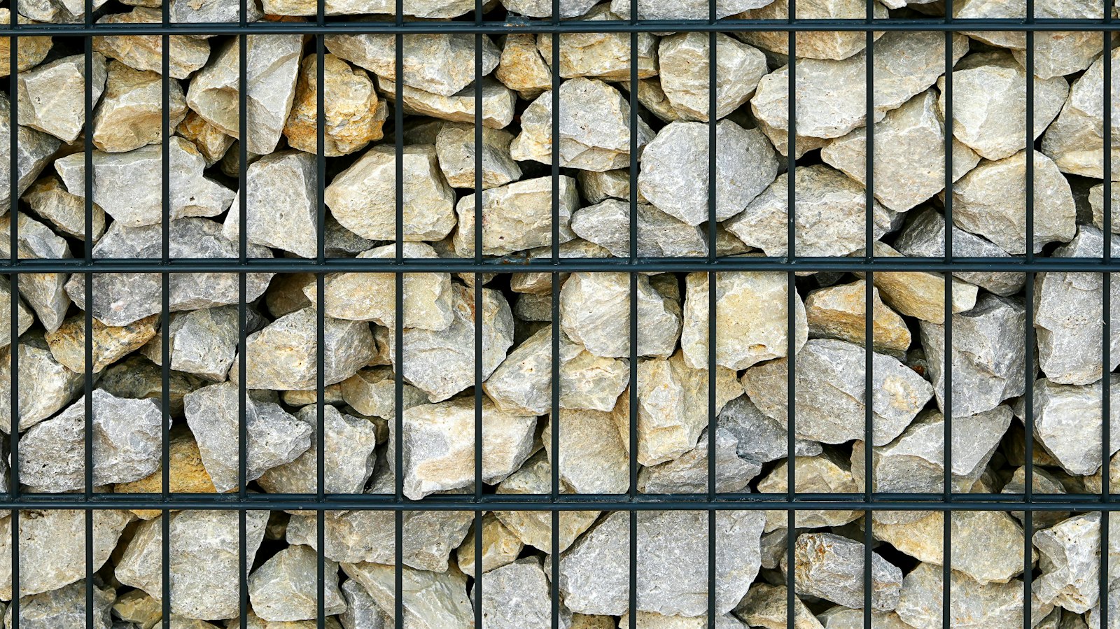 Stone-filled gabion retaining structure